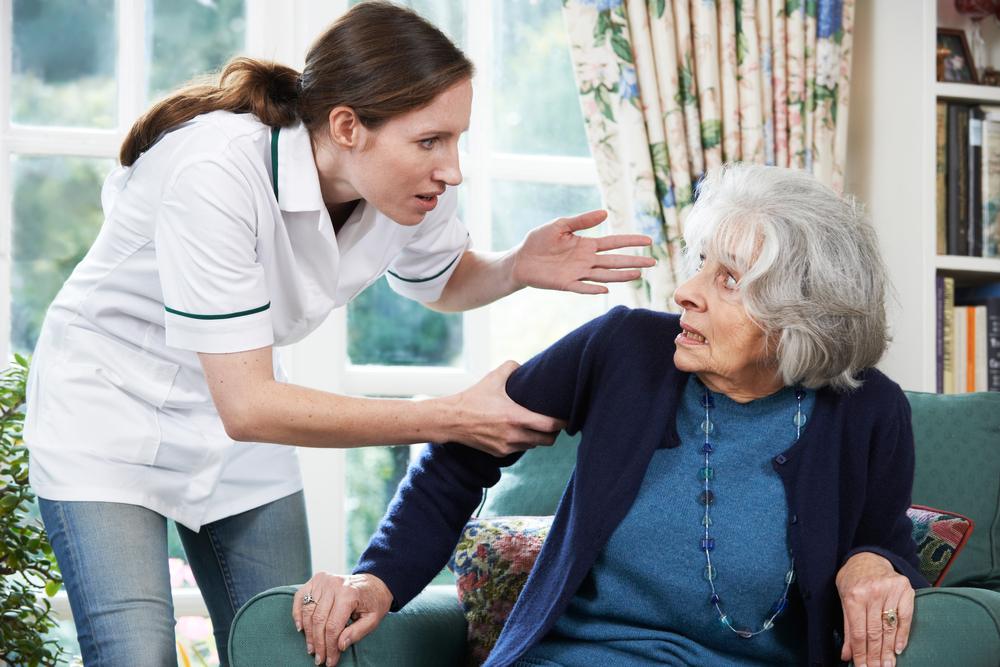 An elderly woman in a wheelchair facing abuse in a nursing home.