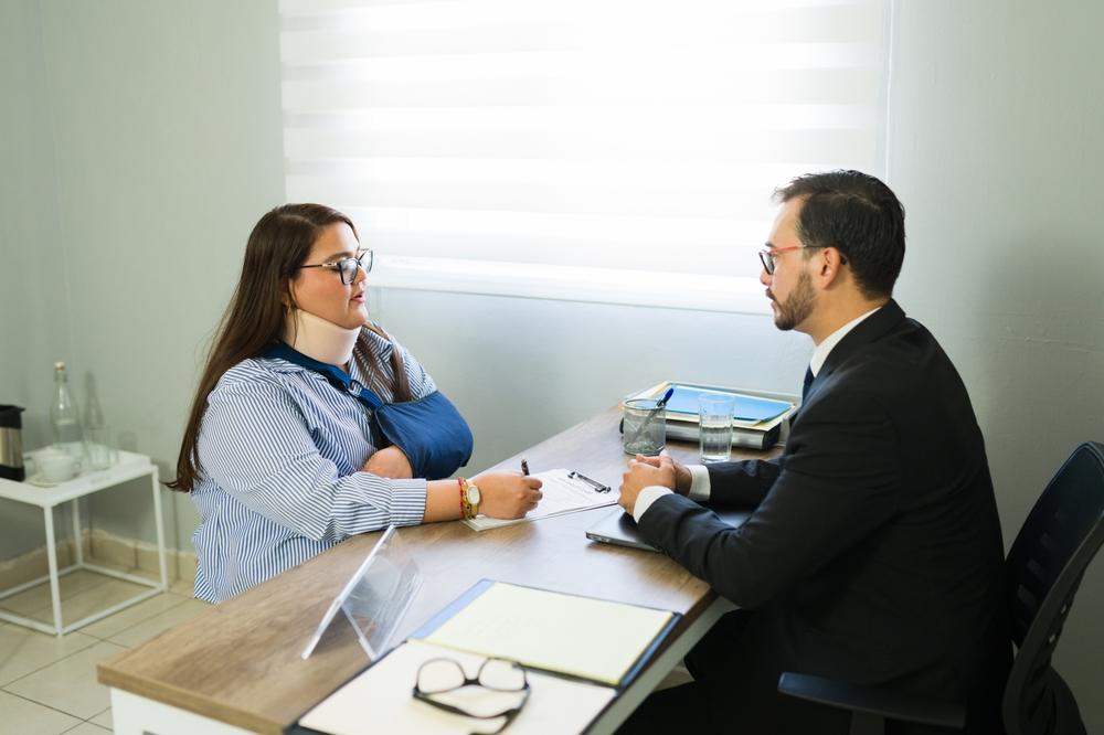An injured woman asks an attorney if she needs a personal injury lawyer