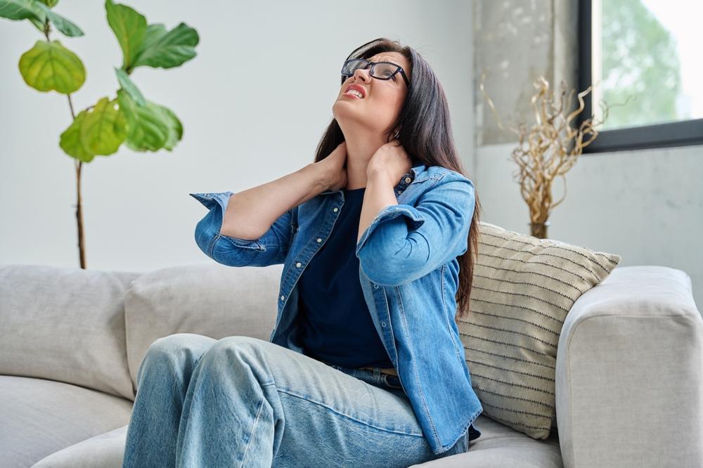 A woman holds her neck in pain and wonders if the Ohio car accident claims statute of limitations has expired for her crash.