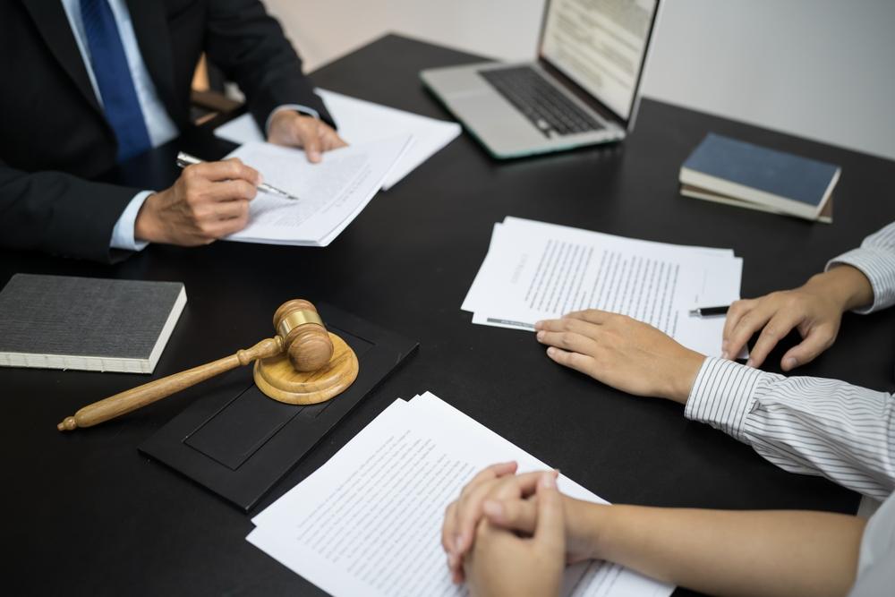 A lawyer meets with clients to discuss legal options related to suspected nursing home sexual abuse and potential civil claims.