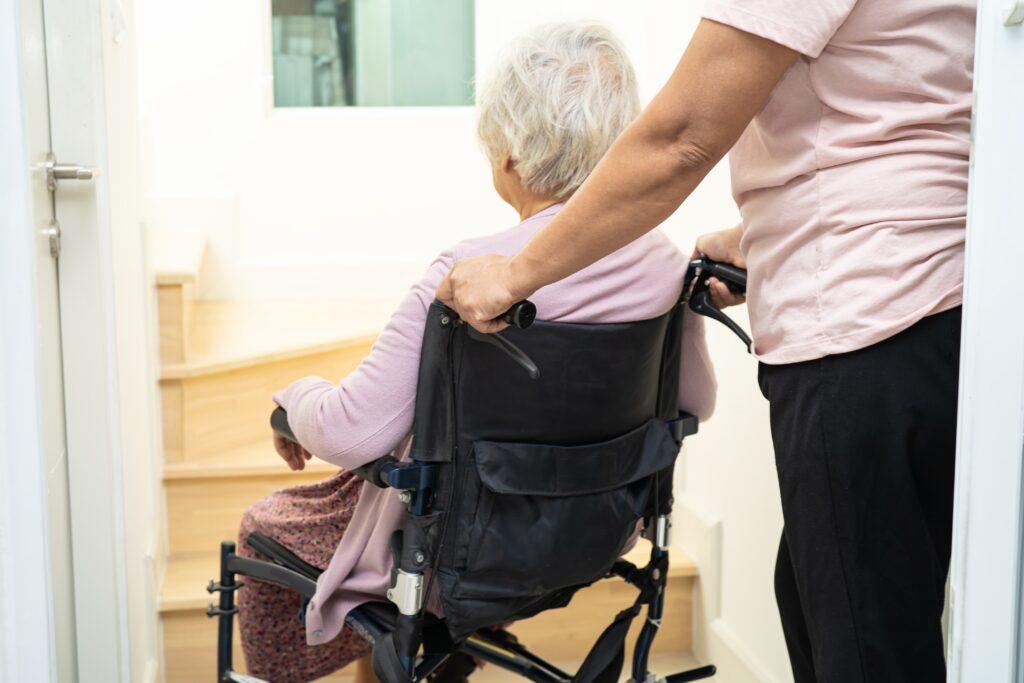 A photo of a lawyer sitting at her desk doing paperwork for an article that explains how to choose a nursing home abuse lawyer.