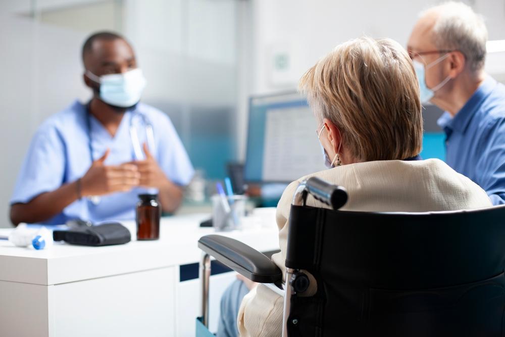 A nurse talks to an older woman. A lawyer can tell you who investigates sexual abuse in Ohio nursing homes.
